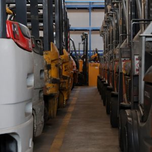 Carrello elevatore in magazzino industriale durante attività logistica e movimentazione merci